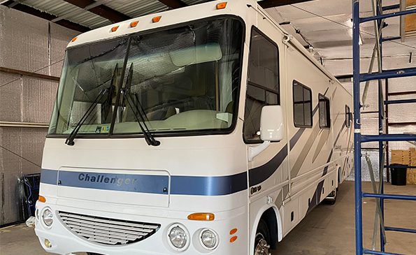 White RV parked in the garage, right angle
